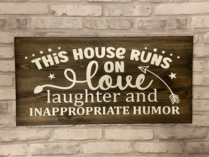 “This house runs on” Sign